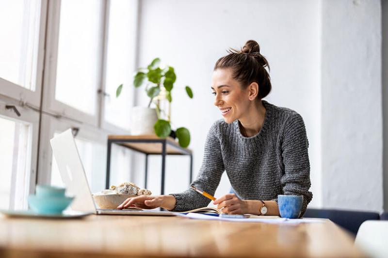 Creative woman using laptop in studio