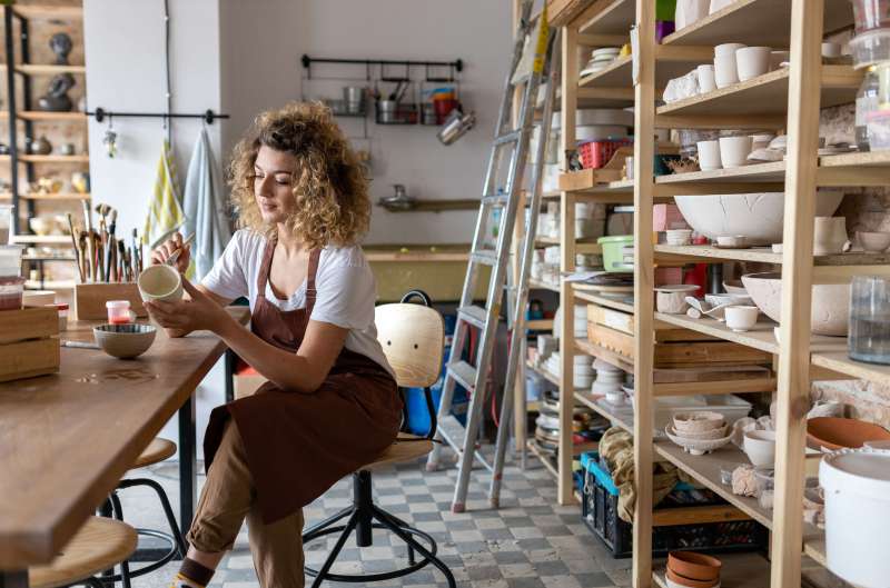 Woman doing pottery in craft studio