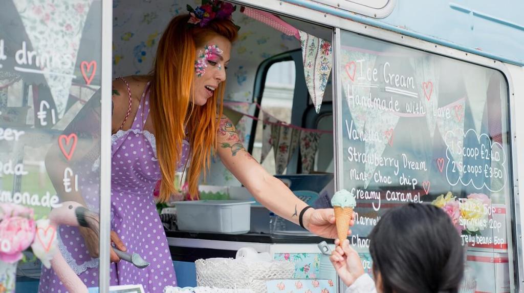 Ice cream van worker handing a customer an ice cream