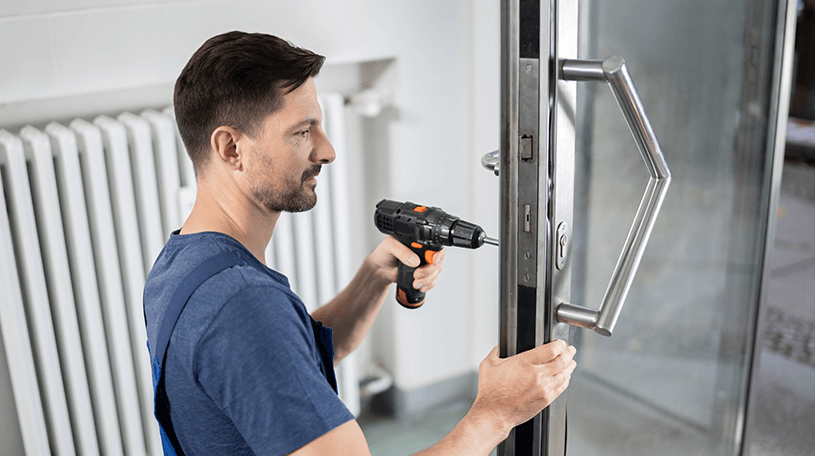 Locksmith drilling the lock on the main door