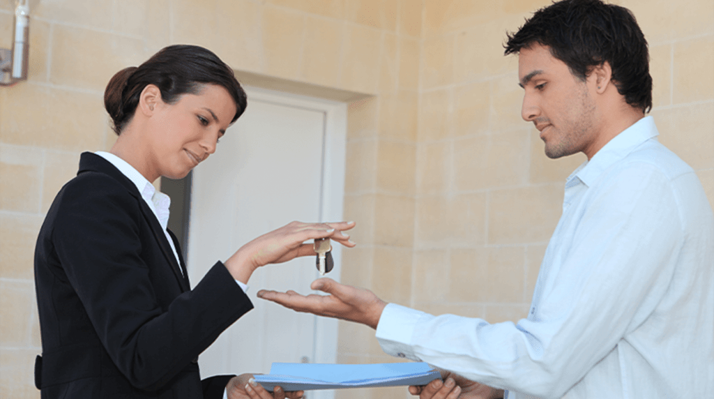 Agent giving a landlord keys to a property