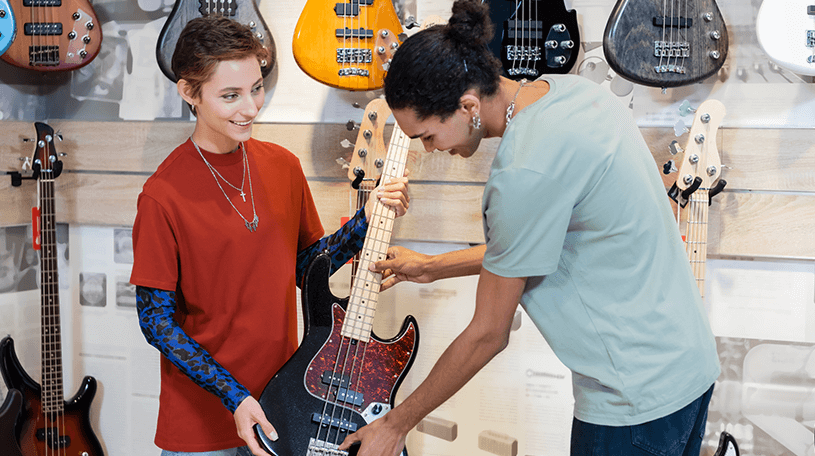 A customer buying a guitar from a music shop