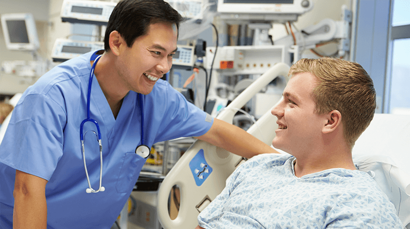A nurse talking to a patient in a hospital