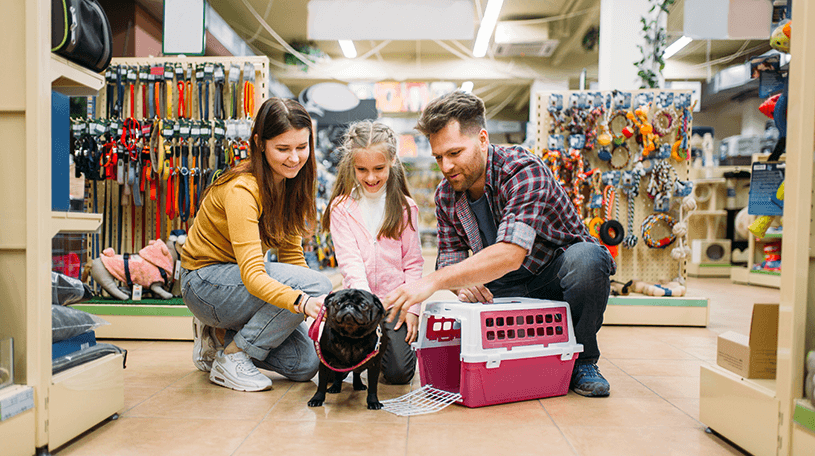 A family petting a dog in a pet store
