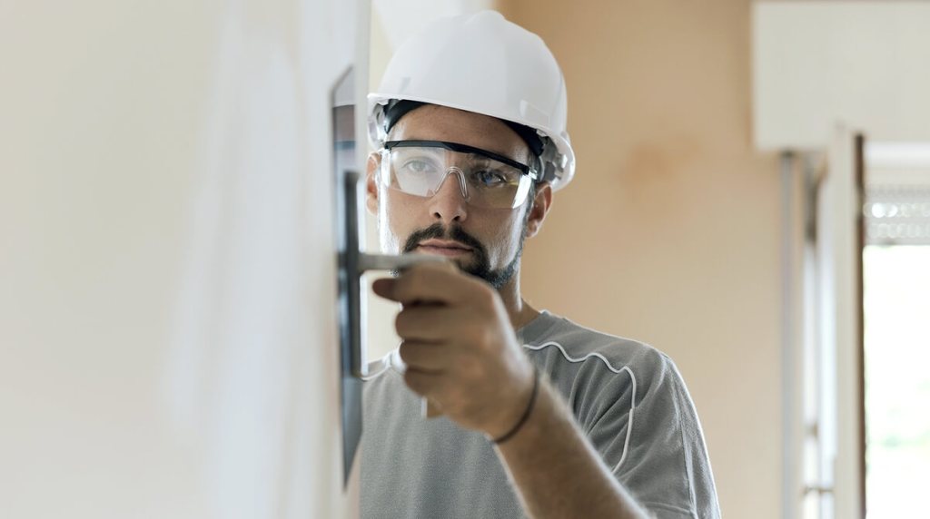 Man plastering the internal wall of a house