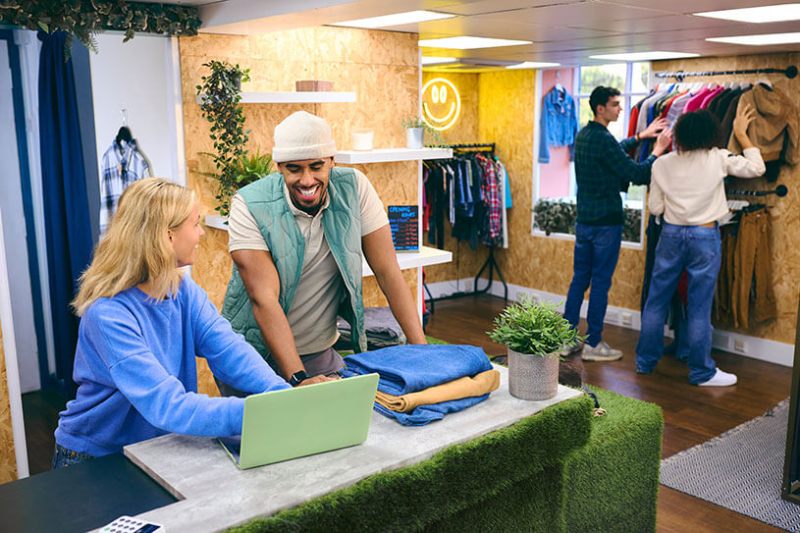 Two sales assistants in a pop-up clothes shop