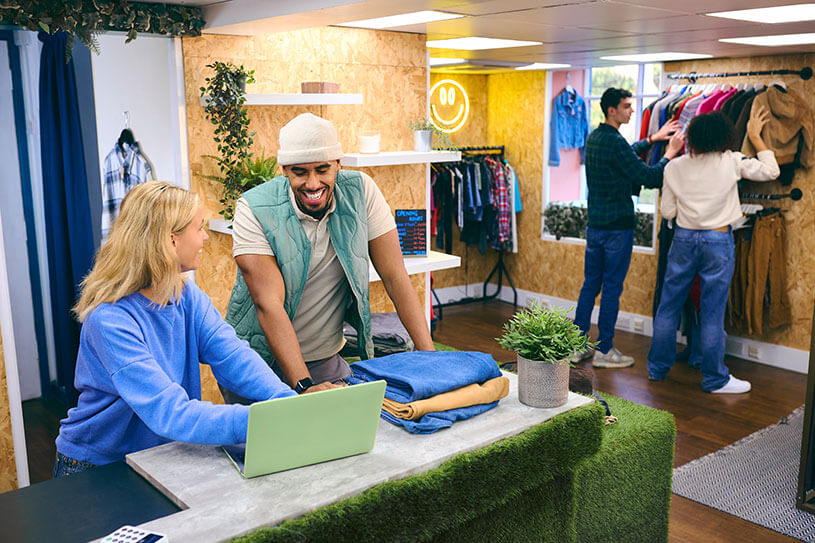 Two sales assistants in a pop-up clothes shop