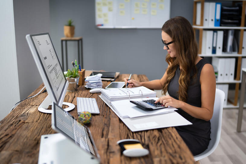 self-employed woman doing her taxes at her computer