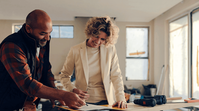 Female shop owner looking at floor plans
