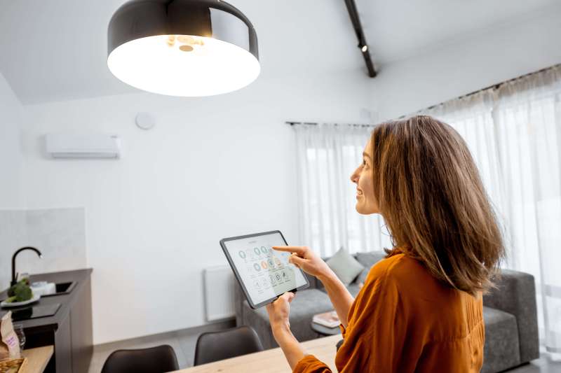 Woman adjusting the light in her home