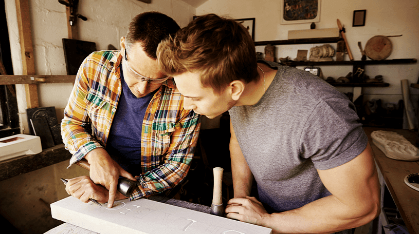Two workmen discussing planning documents