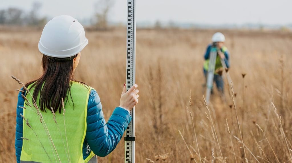 Surveyors working in a field