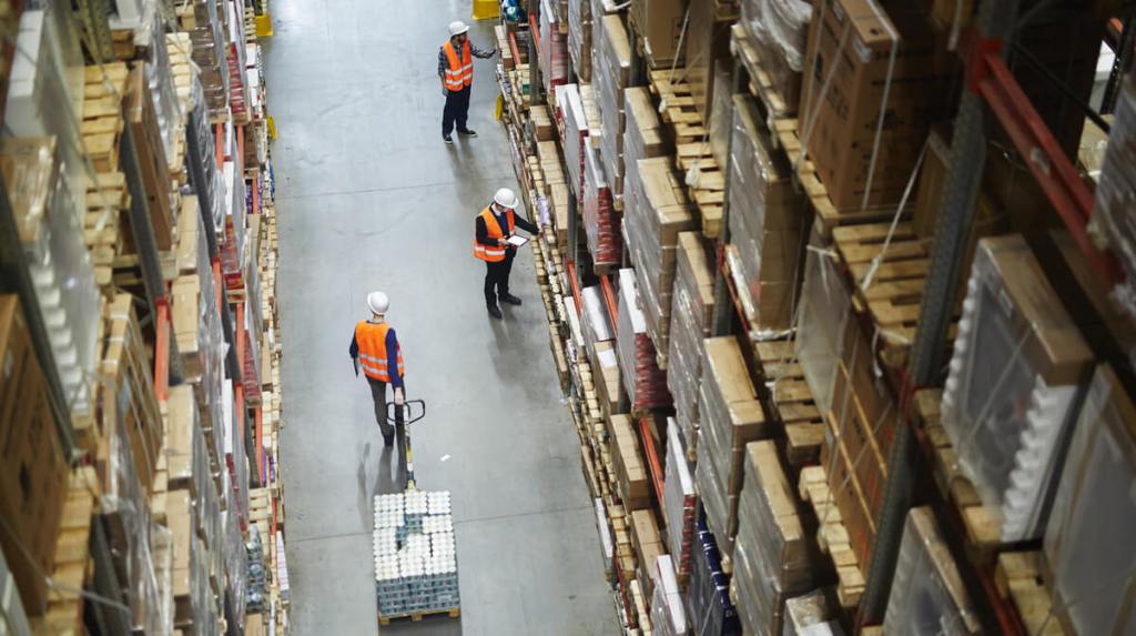 Pallets being loaded in  warehouse