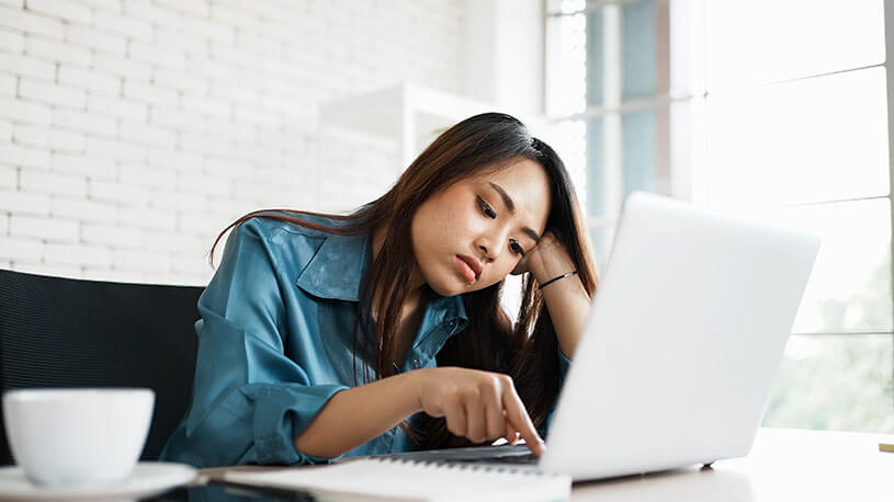 A young gen z employee bored on her laptop may be quiet quitting