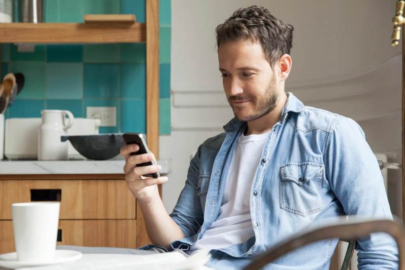 Man browsing LinkedIn on smartphone