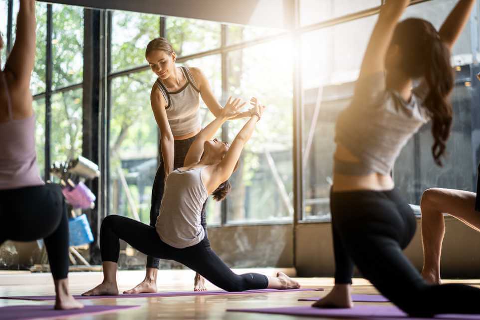 Yoga instructor using scheduling software on tablet