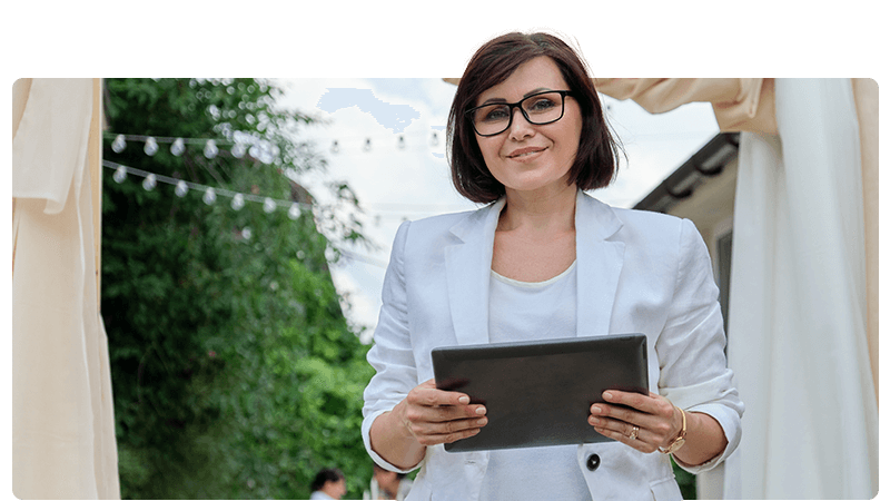 Event organiser stood outside holding a tablet.