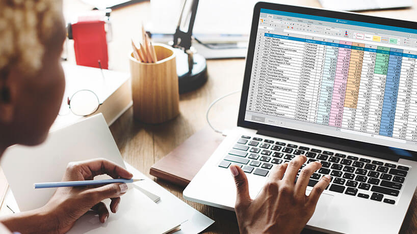 Spreadsheet Document Information Financial Startup Concept Woman filing accounts on laptop