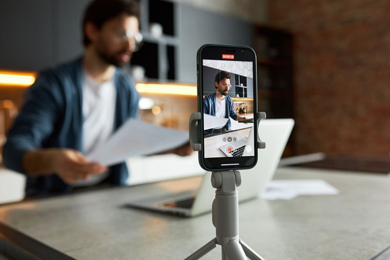 A man filming a YouTube video on his iPhone