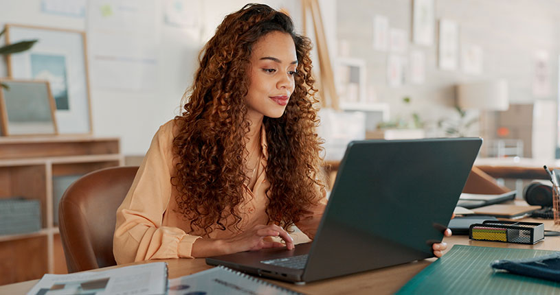 Woman working on a laptop and concentrating