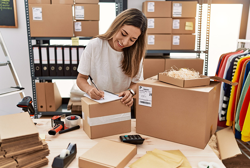 Small business owner packing orders to export