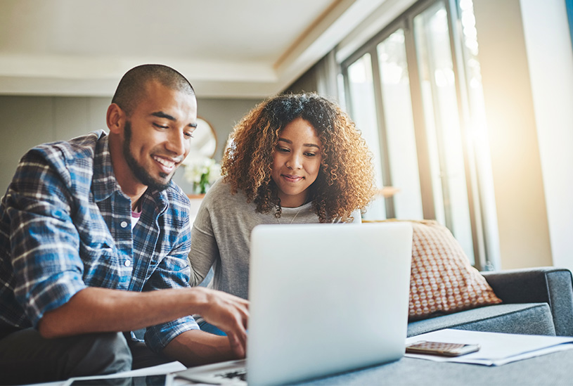 Married couple looking at laptop