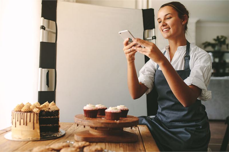 Home baker taking pictures of their cakes