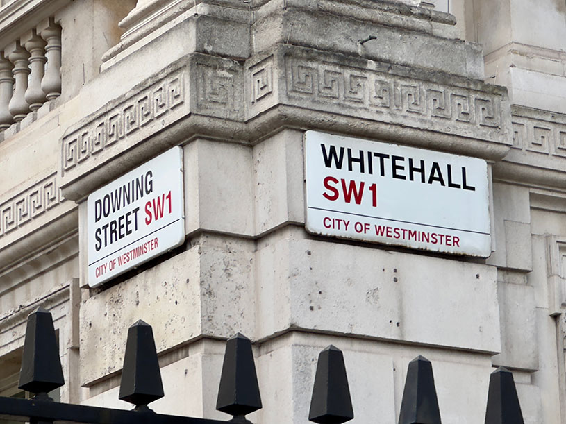 Whitehall and Downing Street SW1 signs on the wall of a government building in City of Westminster, London, England.
