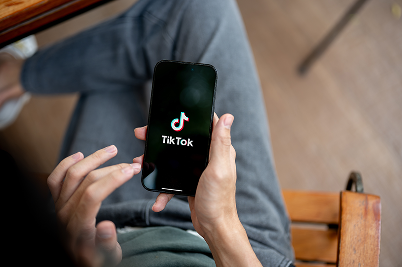 A small business owner goes on TikTok on their phone