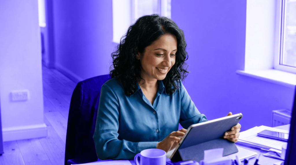 A small business owner pays business tax on her iPad