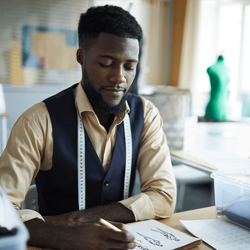 Man sketching with a tape measure