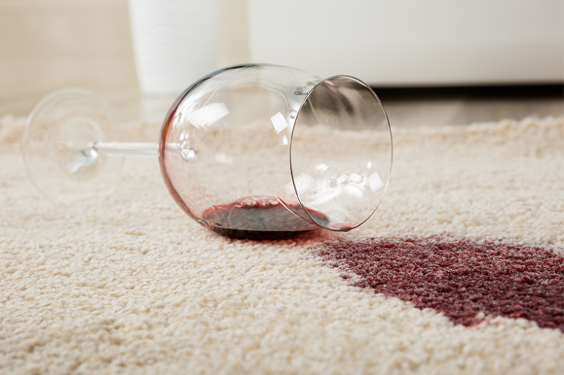 Red wine spill on a carpet in a rental property