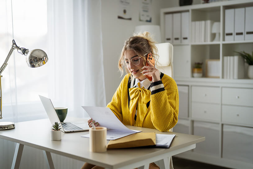 Business owner on the phone, looking at a document