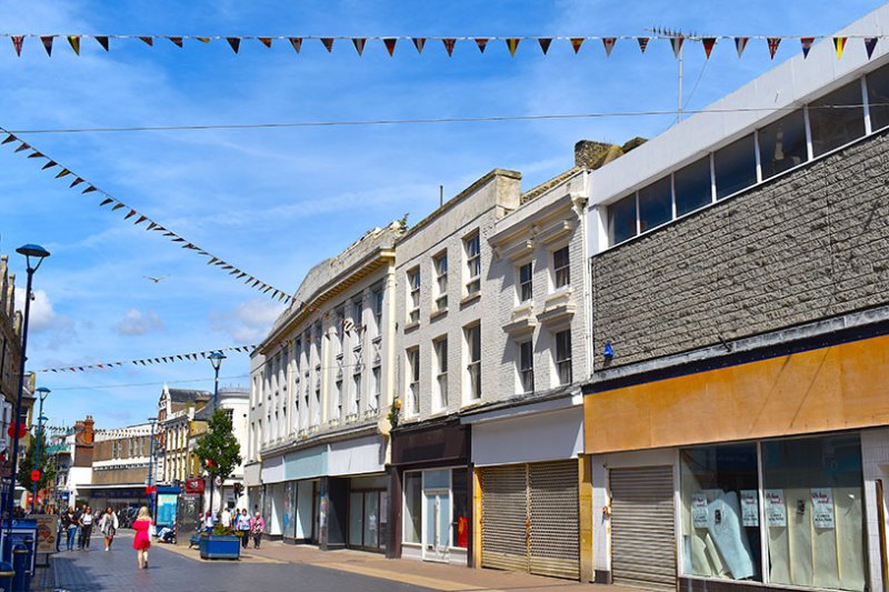 Closed high street with shops and buildings in traditional style. The lively coastal town center of Dover, Kent county, England