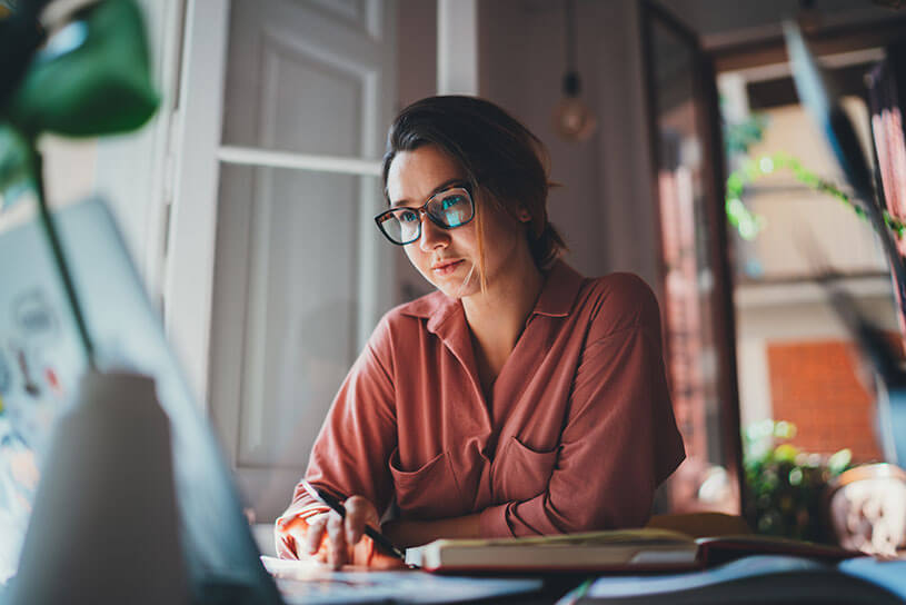 Young female business owner working on a laptop