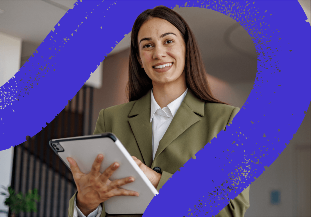 A professional woman holding a tablet and looking directly and smiling